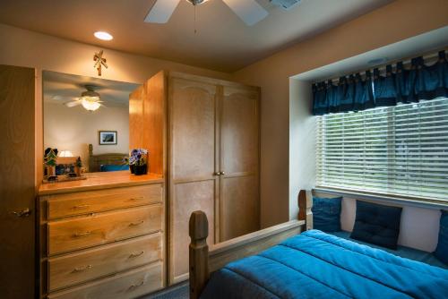 a bedroom with a bed and a dresser and a window at 2A The Terry Cabin in North Wawona