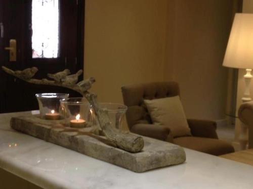a table with candles on top of a table at Nerida Boutique Hotel in Dhimitsana