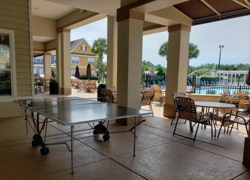 a patio with two ping pong tables and chairs at Kissimmee 3bed Villa Near Disney in Kissimmee