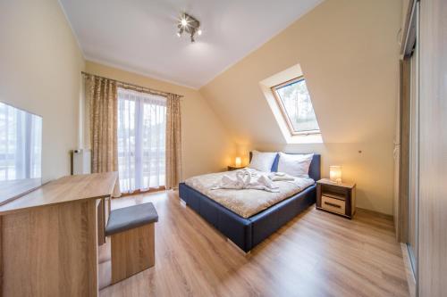 a bedroom with a bed and two windows at Piotr in Łukęcin