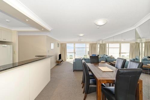 a kitchen and dining room with a table and chairs at 19th Avenue on the Beach in Gold Coast