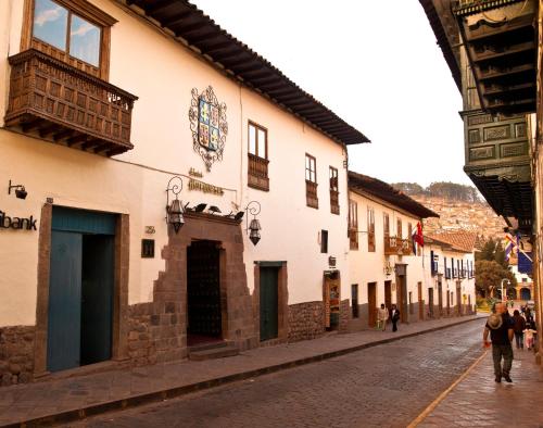 people walking down a narrow street at Hotel Marqueses in Cusco