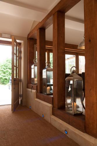 a room with a wall of mirrors with a window at The Wychwood Inn in Shipton under Wychwood