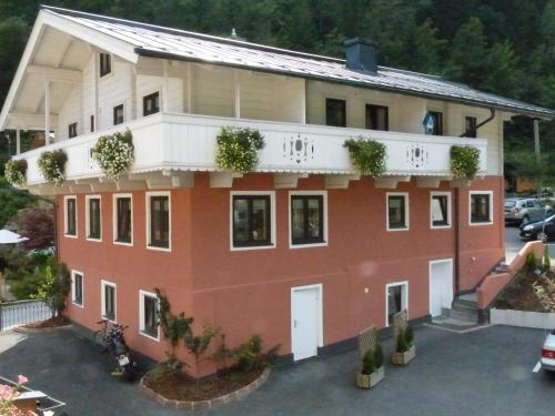 a house with a balcony on top of it at B&B by Zillners in Zell am See