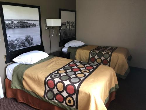 a hotel room with two beds in a room at Super 8 by Wyndham Kingston in Kingston