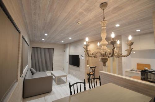 a dining room and living room with a chandelier at enico MtFuji peace in Fujikawaguchiko