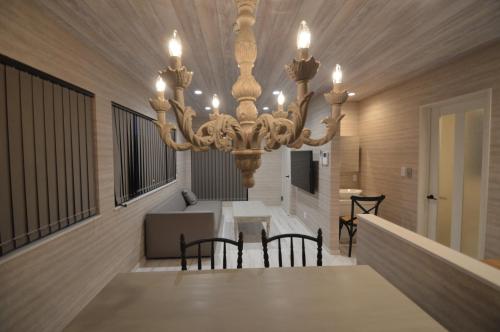 a dining room with a table and a chandelier at enico MtFuji peace in Fujikawaguchiko