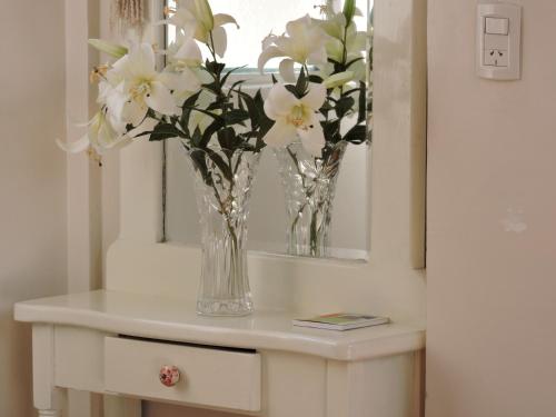 a vase of flowers on a table in a room at A & E Buenos Aires in Buenos Aires