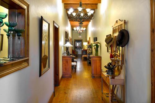 a hallway filled with furniture and a chandelier at Centre-Ville Guest House in Franschhoek