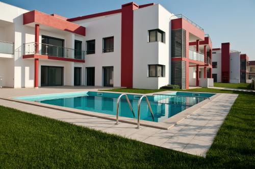 a house with a swimming pool in front of it at Bica Luxury Penthouse in Baleal