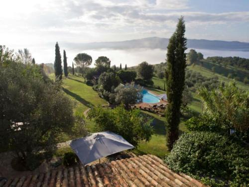 eine Aussicht auf ein Haus mit einem Regenschirm in der Unterkunft Tenuta Di Canonica in Todi