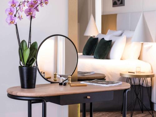 Кровать или кровати в номере Le Louis Hotel Versailles Château - MGallery Collection
