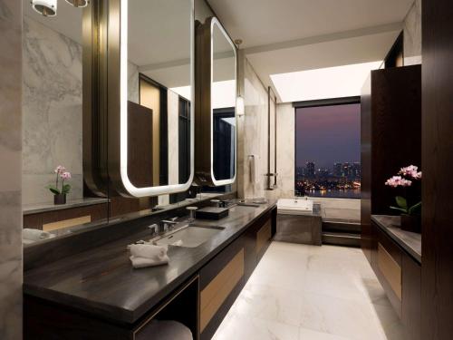 a bathroom with two sinks and a large mirror at Grand Mercure Ambassador Hotel and Residences Seoul Yongsan in Seoul
