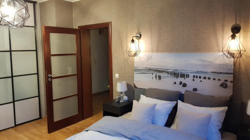 a bedroom with a bed with white pillows at Siesta Apartments in Sopot