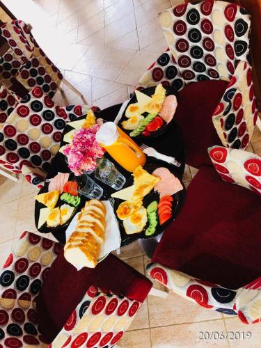 a table with many different types of food on it at Hotel Ambasador Garden in Lezhë