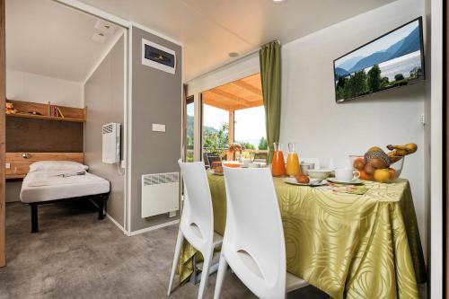 a kitchen and dining room with a table and chairs at Wellness Landhaus Parth in Ossiach