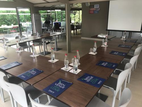 a conference room with a long table with bottles on it at Campanile Colmar - Parc des Expositions in Colmar