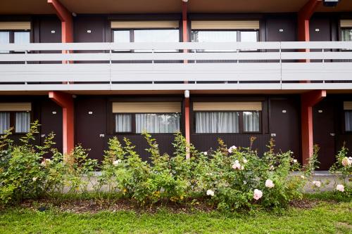 a building with flowers in front of it at Campanile Colmar - Parc des Expositions in Colmar