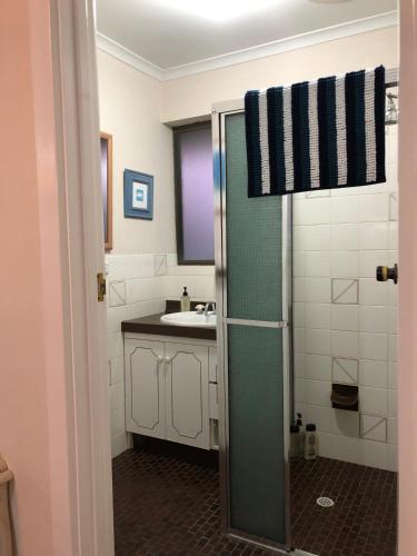 a bathroom with a shower and a sink at The Castle - Goolwa Beach in Goolwa South