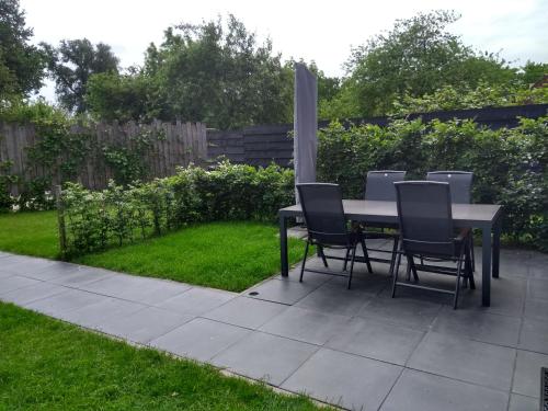 a table and chairs on a patio in a yard at Veers Vertier in Veere