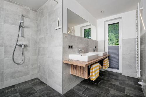 a bathroom with a sink and a shower at Wellness Landhaus Parth in Ossiach