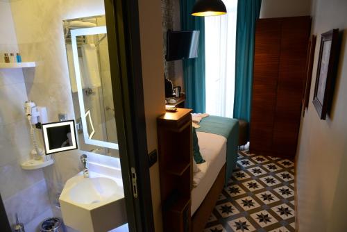 a small bathroom with a sink and a bed and a sink at Pera Luna Residence in Istanbul
