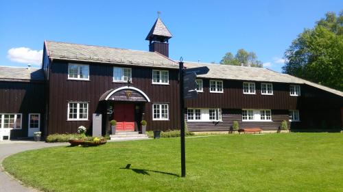 a large brown building with a red door at Lysebu Hotel in Oslo