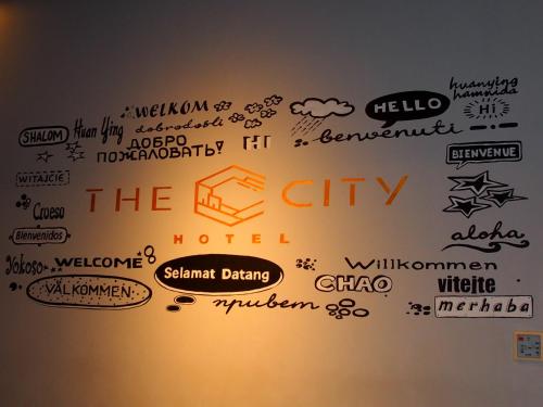 a wall filled with lots of different words at The City Hotel in Ambon
