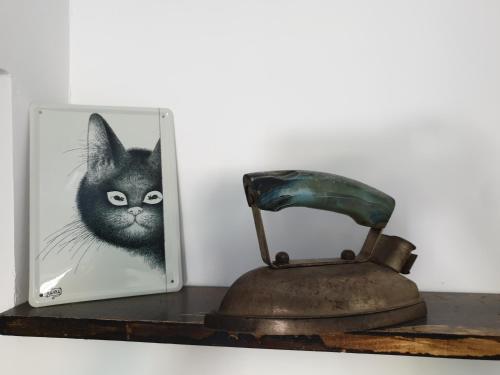 a picture of a black cat and an old telephone at Casa Pisica Noastra in Breaza
