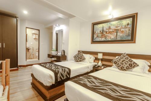 Postel nebo postele na pokoji v ubytování Hotel Shreesu