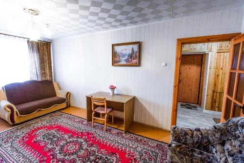 a living room with a couch and a table at Квартира на Козлова 13 in Salihorsk