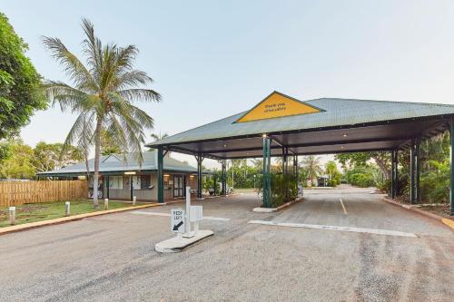 a gas station with a yellow sign on top of it at RAC Cable Beach Holiday Park in Broome