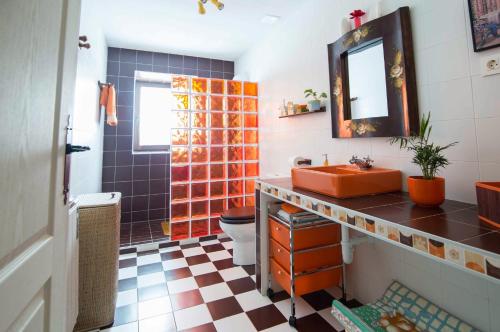 a bathroom with a sink and a toilet and a mirror at Las Tres Herraduras in Artazu