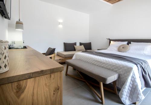a bedroom with a bed and a couch at Oro Suites in Kinion