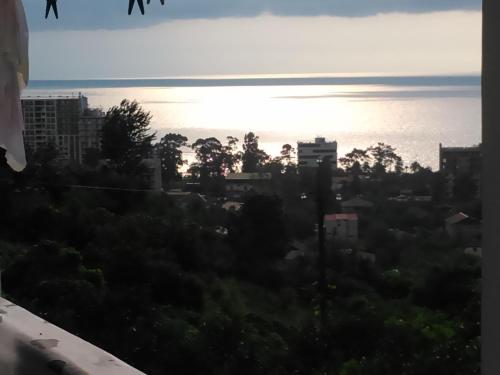 a view of the sun setting over the ocean at Guest house maka in Gonio