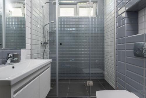 a bathroom with a shower and a toilet and a sink at Riviera Zoloche Resort & Spa in Vishenki