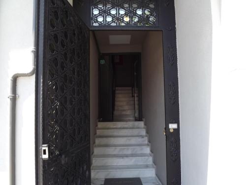 an entrance to a building with stairs and a black door at ACR PALAS in Edirne
