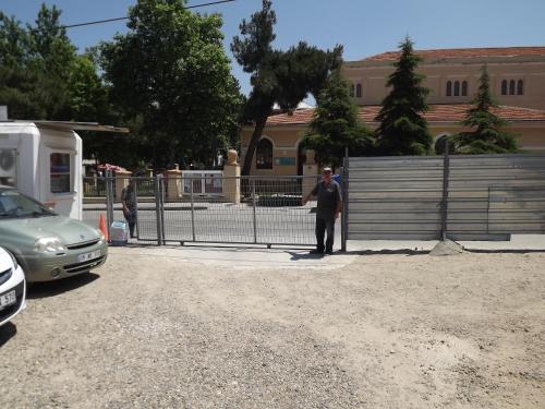 a man standing next to a fence in front of a building at ACR PALAS in Edirne