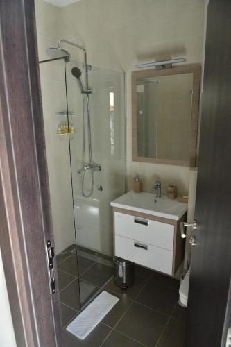 a bathroom with a shower and a sink at Helada Apartments in Tivat