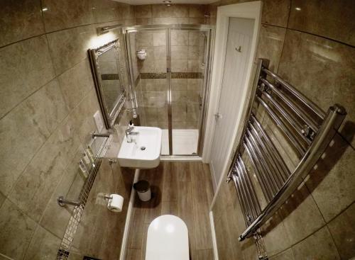a small bathroom with a sink and a toilet at The Vine B & B in South Thoresby