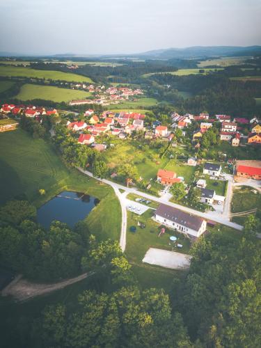 an aerial view of a town with a road and a lake at Penzion Na Podlesí ve Zlaté Koruně in Zlatá Koruna