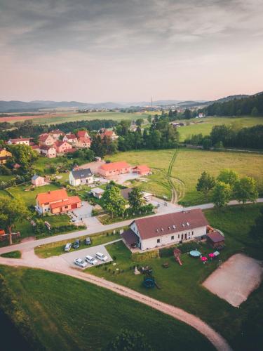 an aerial view of a small village with a house at Penzion Na Podlesí ve Zlaté Koruně in Zlatá Koruna