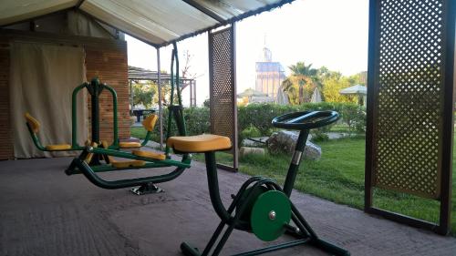 a gym with two exercise bikes and a swing at Orpheas Resort Hotel (Adults Only) in Georgioupolis