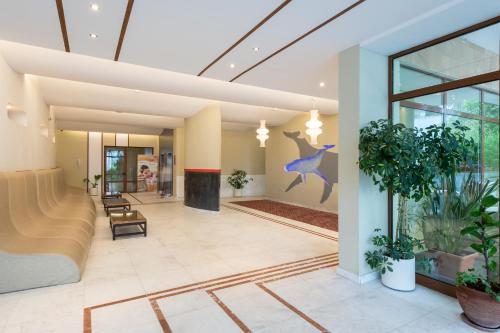 a lobby of a building with plants on the walls at Garden of Eden Complex in Sveti Vlas