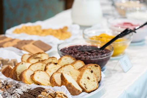 a table topped with different types of bread and other desserts at Garden of Eden Complex in Sveti Vlas
