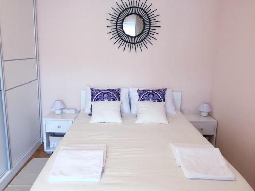 a bedroom with a large bed with a mirror at Lila apartmani in Baošići