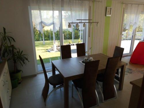 a dining room with a wooden table and chairs at Gästehaus Querenhorst in Querenhorst