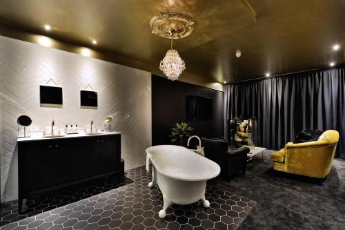 a large bathroom with a tub and a sink at Van der Valk Hotel Sassenheim - Leiden in Sassenheim