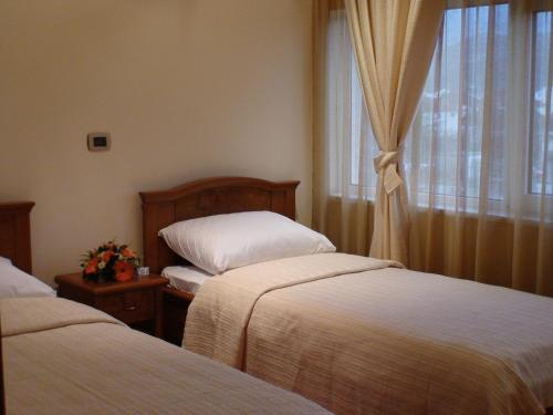 Ένα ή περισσότερα κρεβάτια σε δωμάτιο στο Garni Hotel BaMBiS