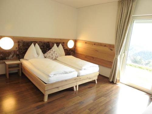 a bedroom with a bed and a large window at Apartment Barbara in Mutters